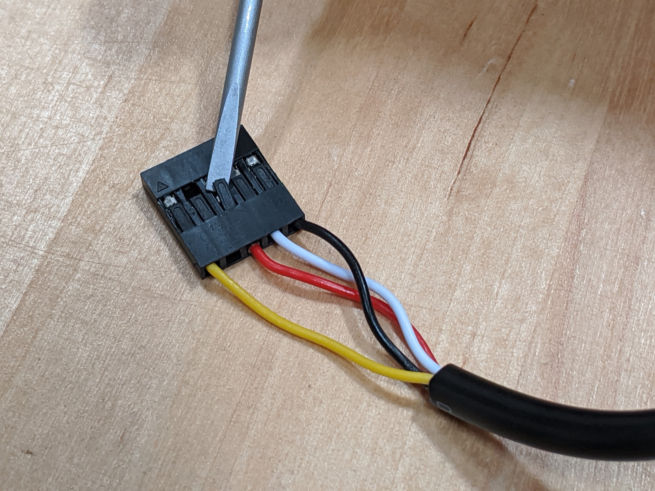 lift black plastic tab for red wire